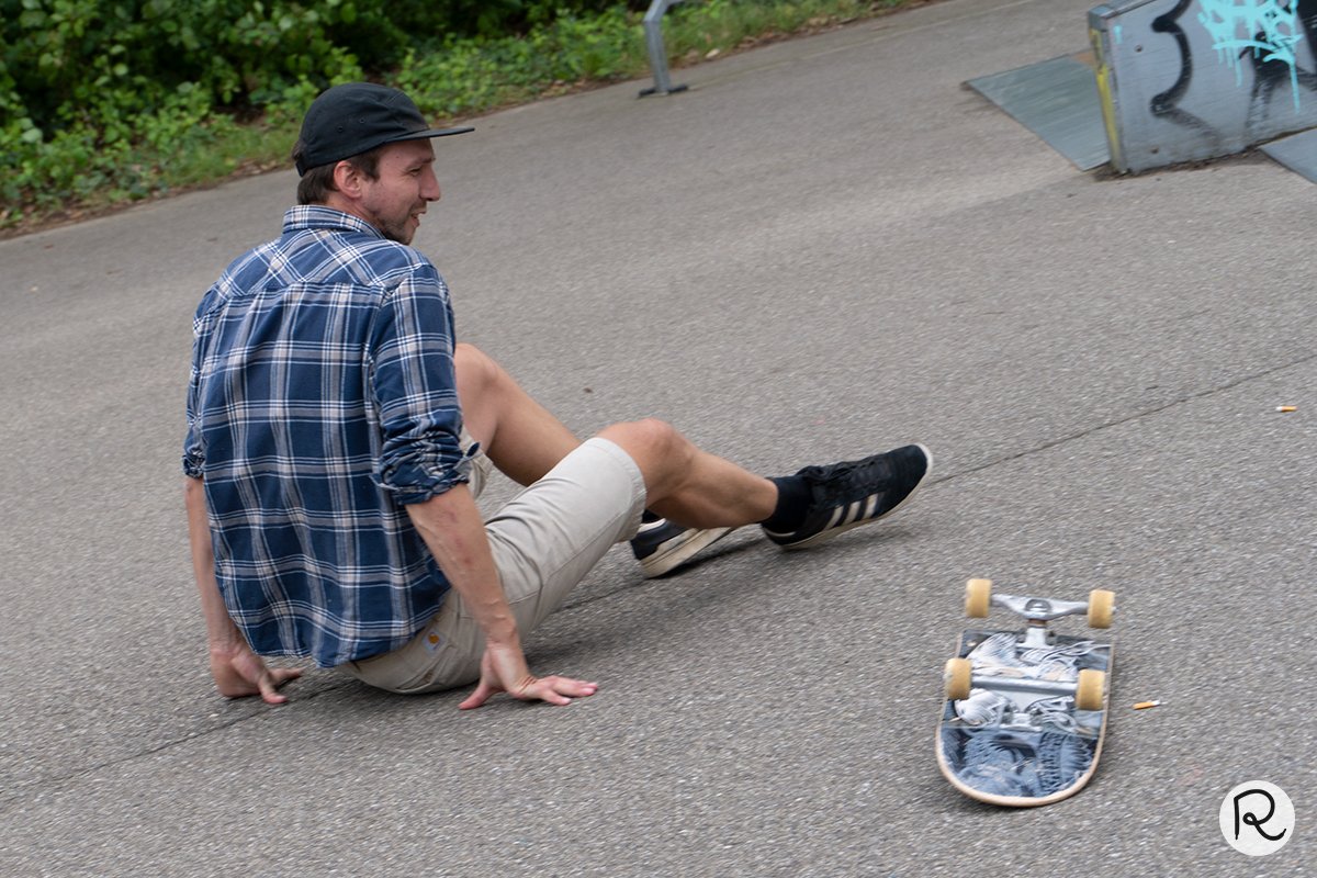skateboarder laughing off a fall